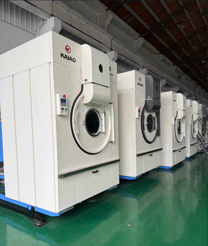 Why is there a 20-minute difference in drying time between two 100 kg dryers? 100kg industrial commercial tumble dryers in factory row